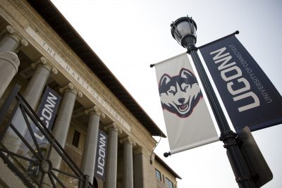 The front of the Hartford Times Buildings with UConn flags in front of it