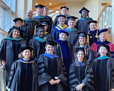 SPP Faculty standing on the stairs at the Bushnell